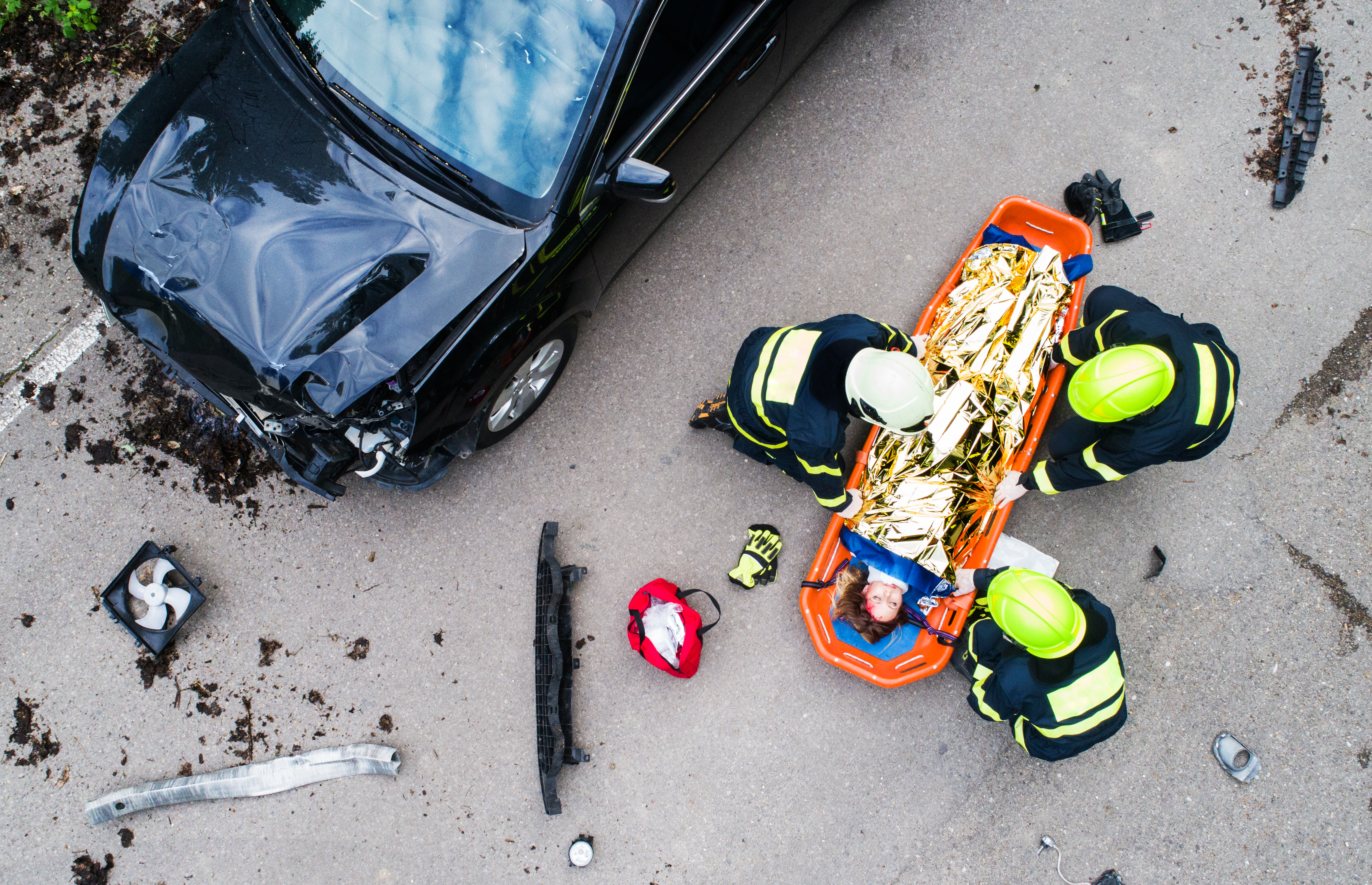 Paramedics treating a patient after a car accident.