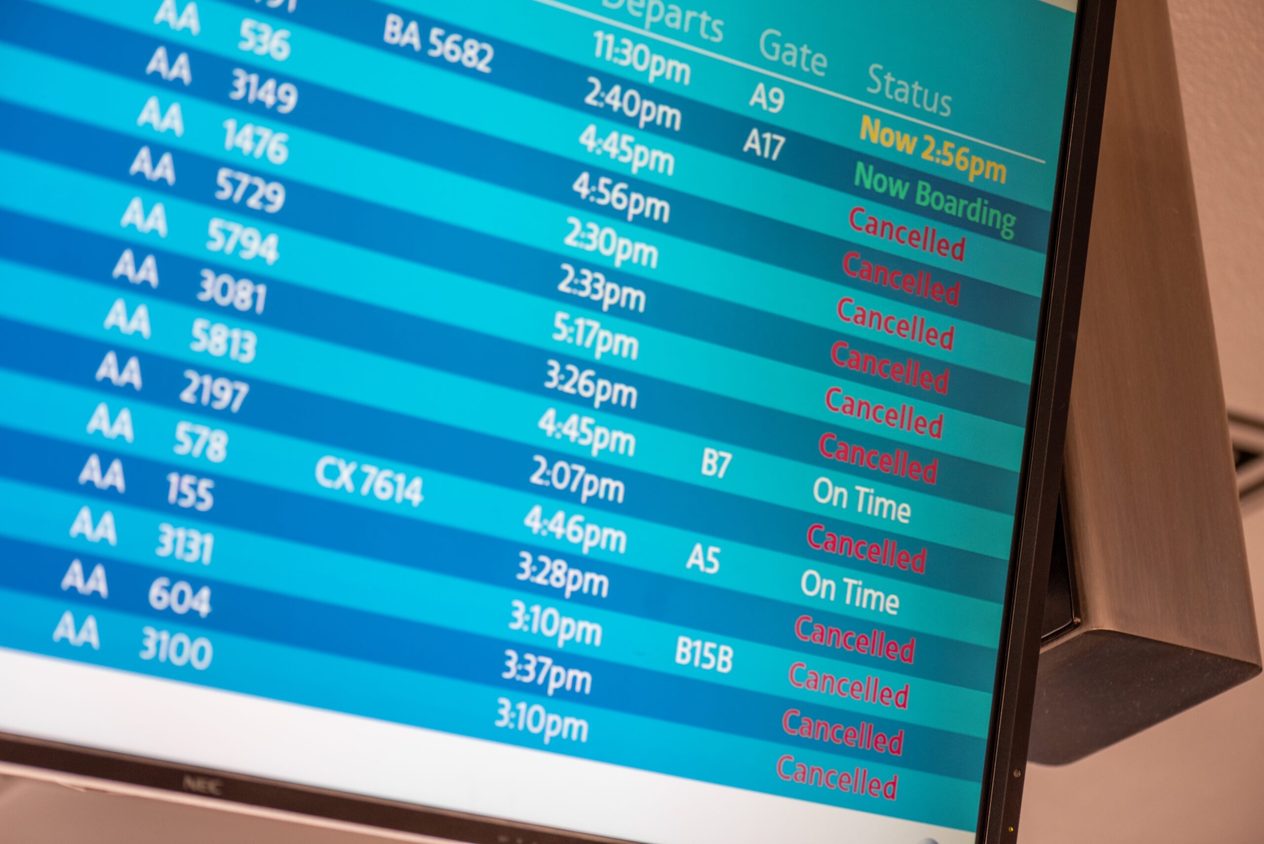 Flight information board showing many cancelled flights due to increased evacuation demand.