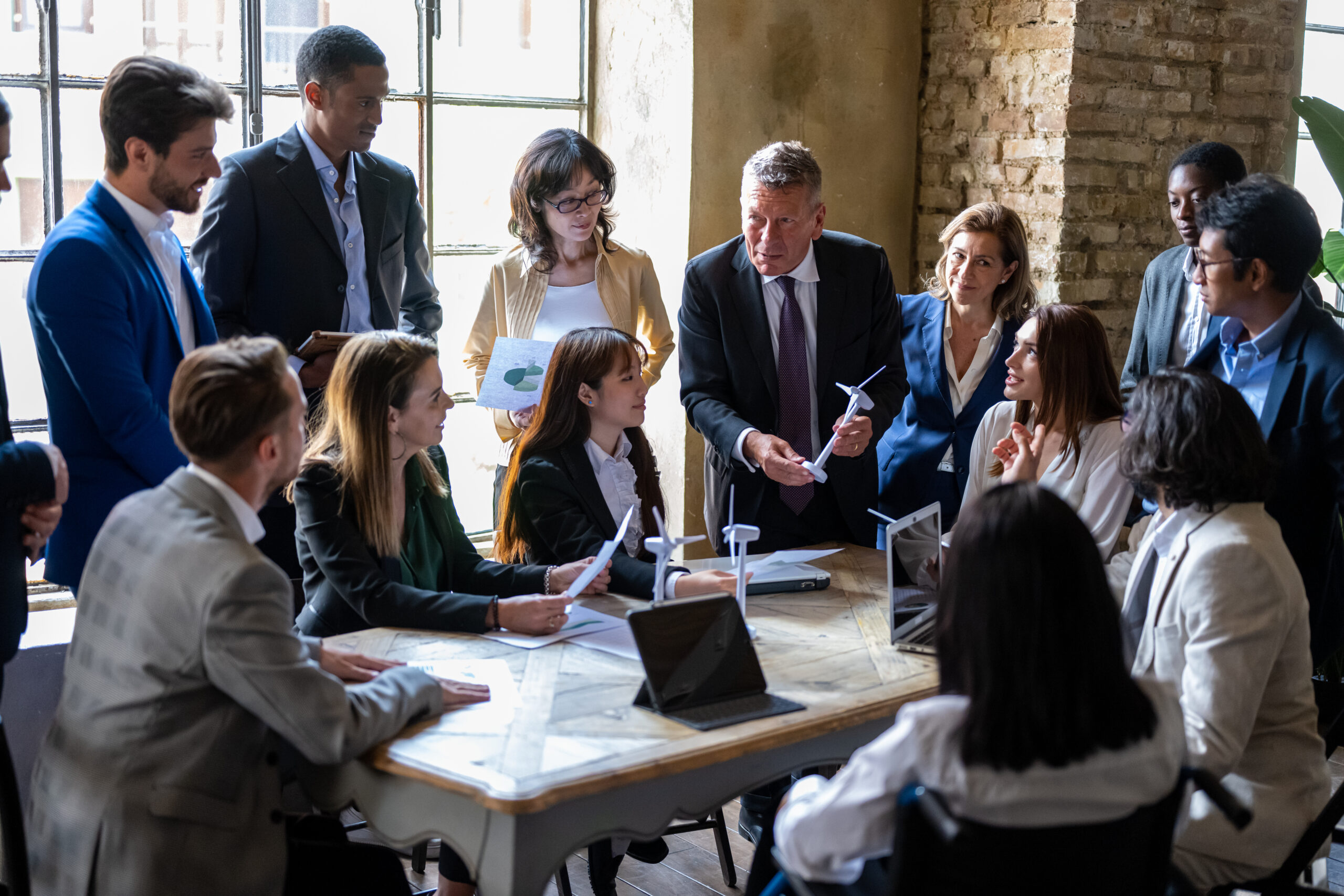 Many business people gathered in a meeting room.