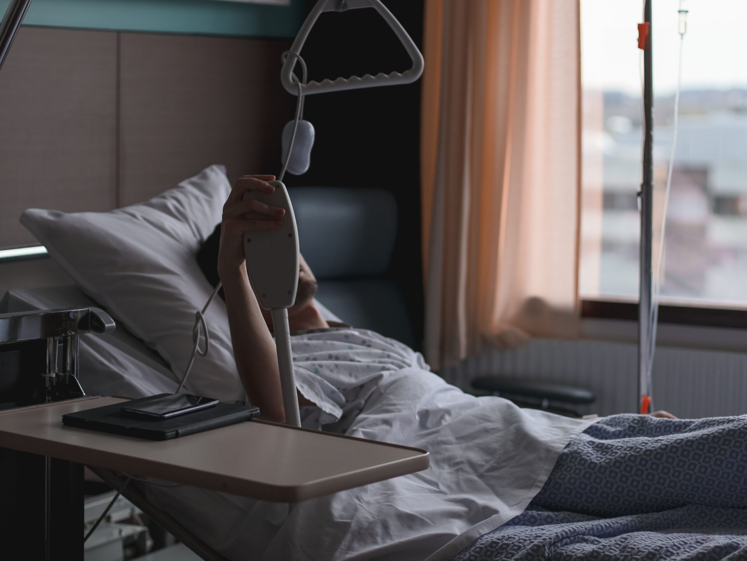 A patient lying in a hospital bed waiting for treatment.